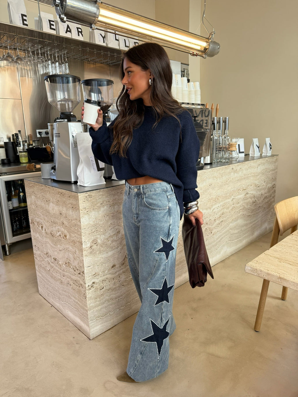 Women's light blue wide leg jeans with studded star leg details