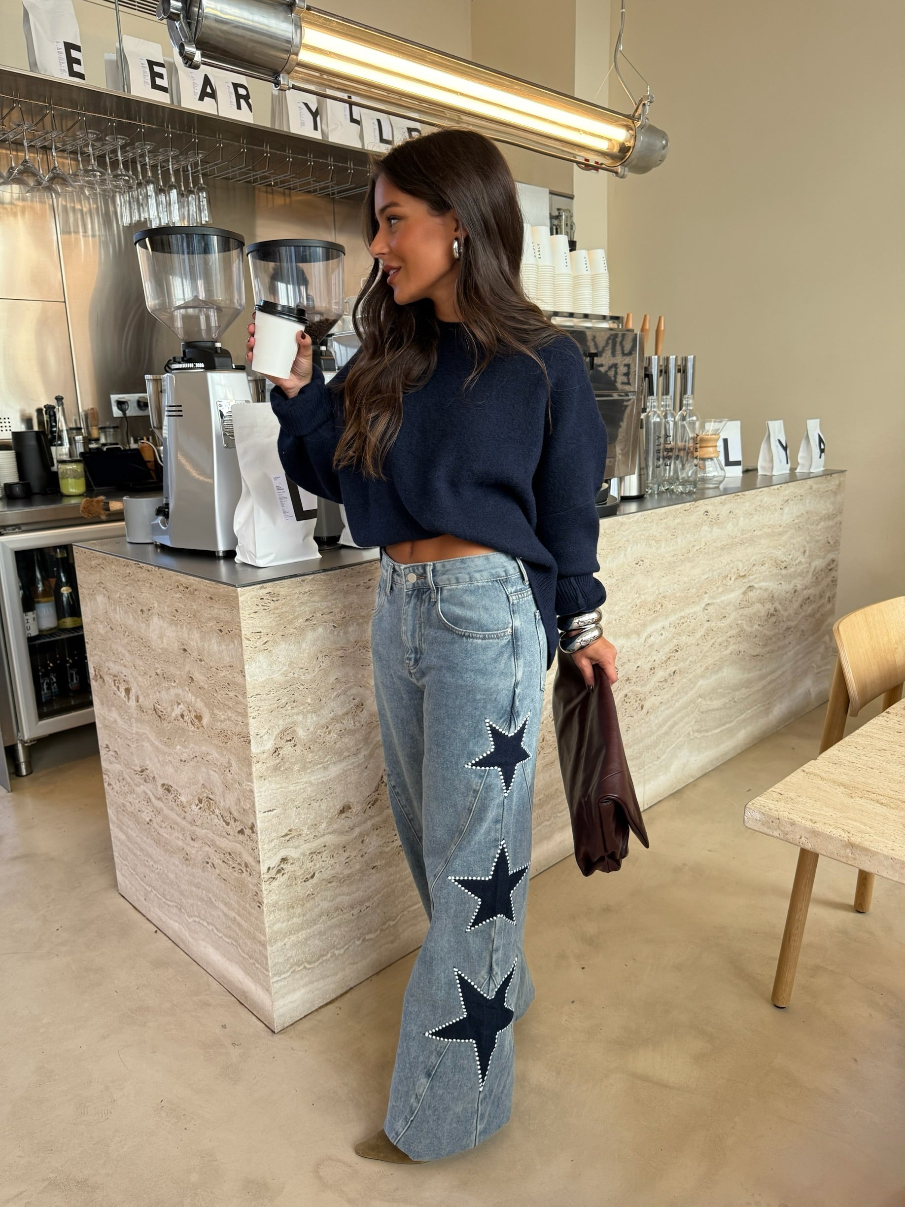 Women's light blue wide leg jeans with studded star leg details