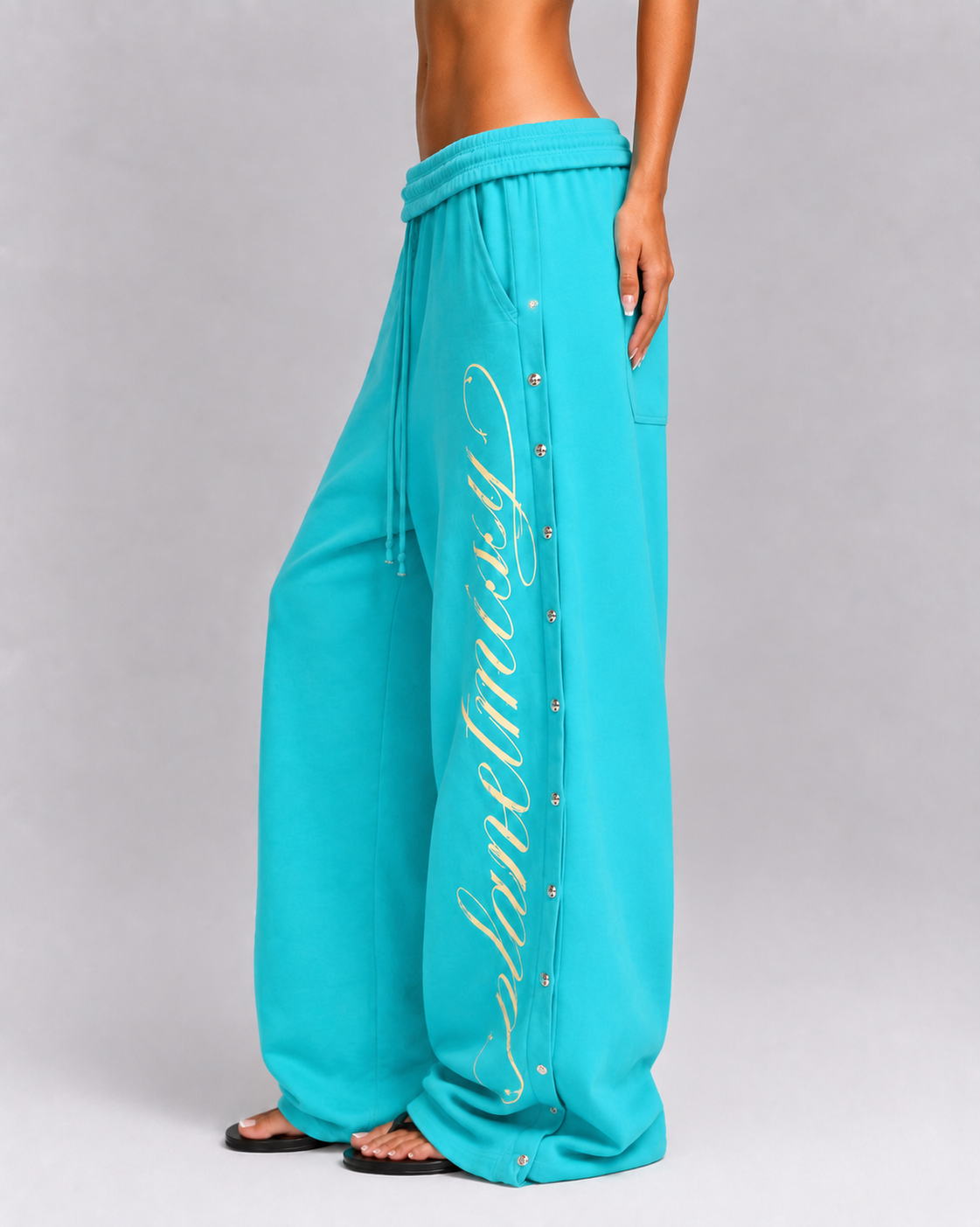 Women's turquoise wide leg jogger trousers with side snaps and drawstring waist