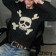 Men's black sweater with a cream skull and crossed-bones graphic