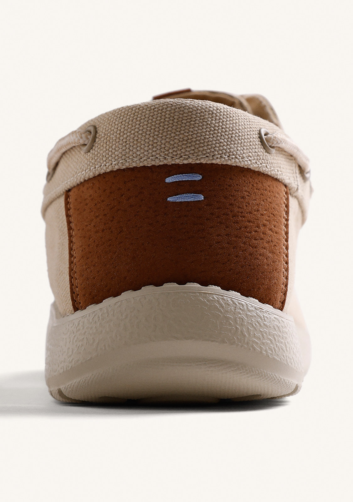 Beige canvas Wallabee loafers with lace-up fronts and moc toes