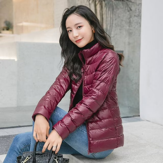 Women's quilted puffer jacket with high collar, long sleeves and front zip