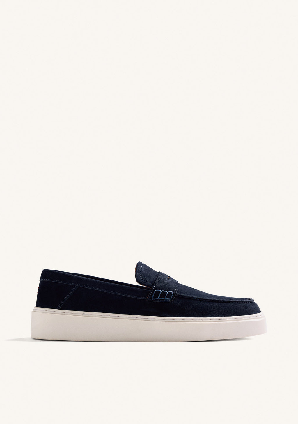 Navy slip-on penny loafers with decorative strap detail and contrasting flat soles