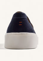 Navy slip-on penny loafers with decorative strap detail and contrasting flat soles