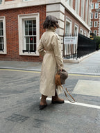Women's beige long trench coat with high collar, buttons and tied waist belt