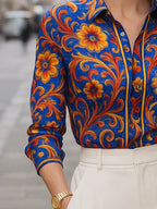 Women's blue floral button blouse with pointed collar and long sleeves