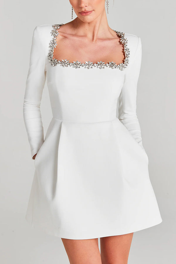 Women's velvet mini dress with embellished square neckline, long sleeves and flared skirt
