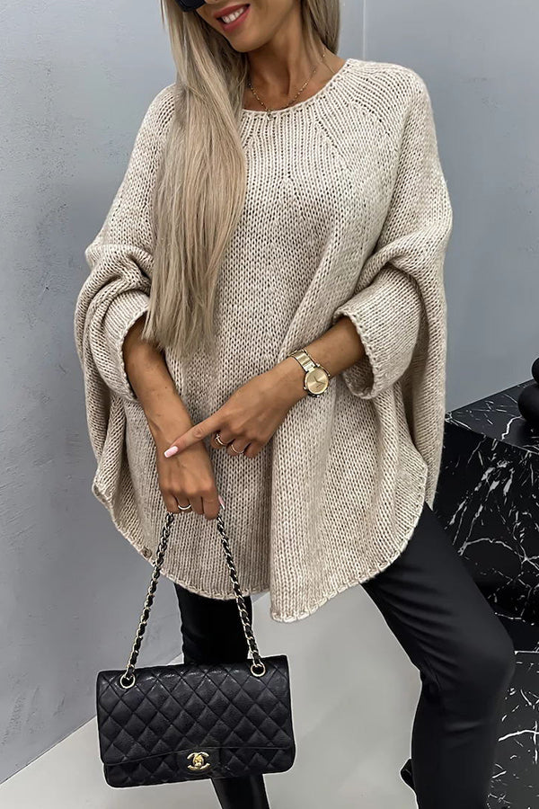 Women's loose knit poncho sweater with crew neckline and wide sleeves
