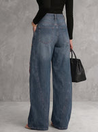 Women's high-waisted wide-leg jeans with red floral embroidery and gold eyelets