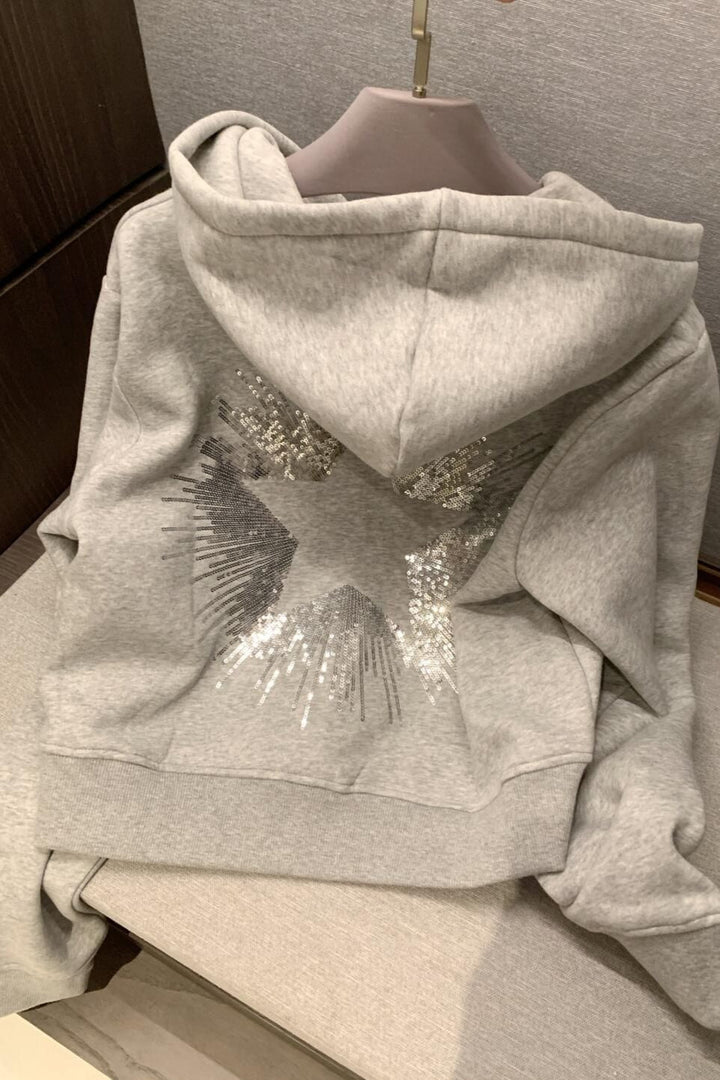 Cropped hooded pullover with long sleeves and a large sequin star design on the back