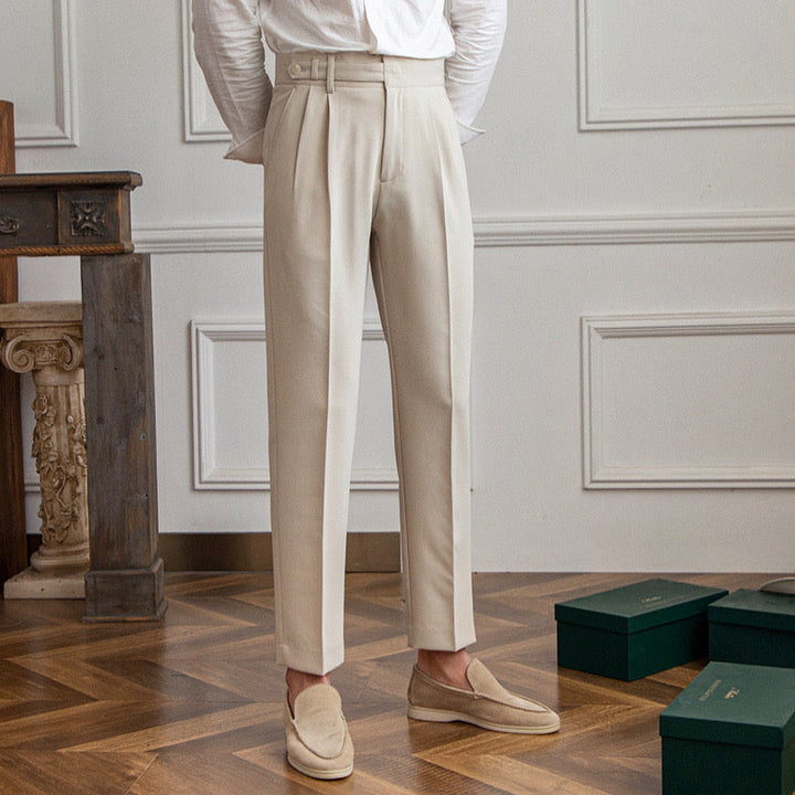 Women's high-waisted pleated straight-leg trousers shown in beige and black