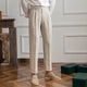 Women's high-waisted pleated straight-leg trousers shown in beige and black