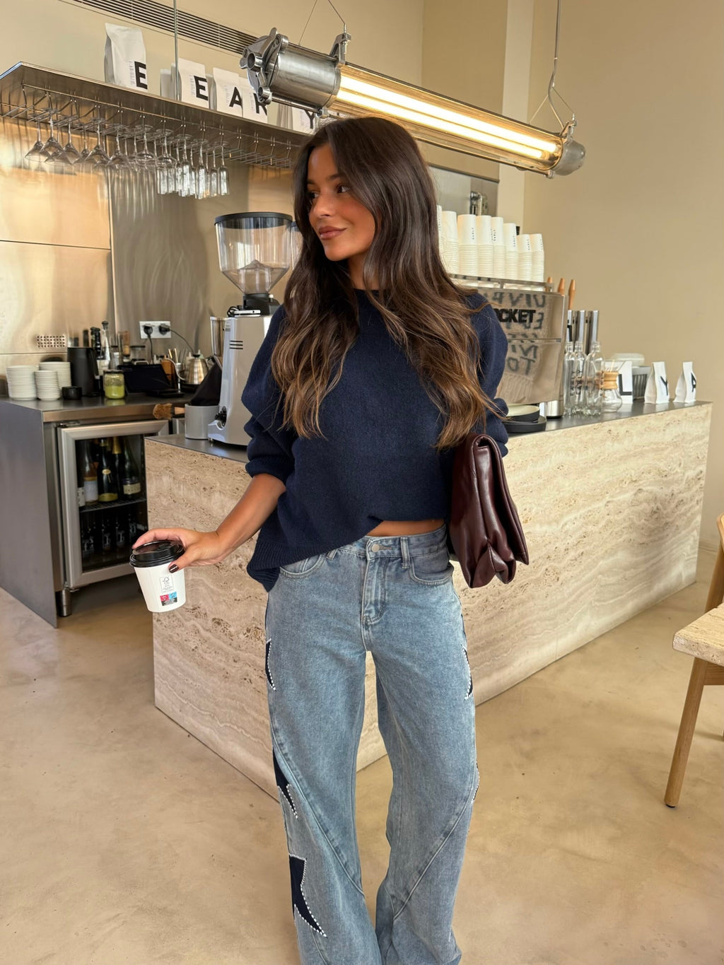 Women's light blue wide leg jeans with studded star leg details