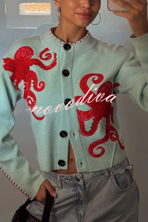 Women's pale blue cardigan with red octopus graphics and button front