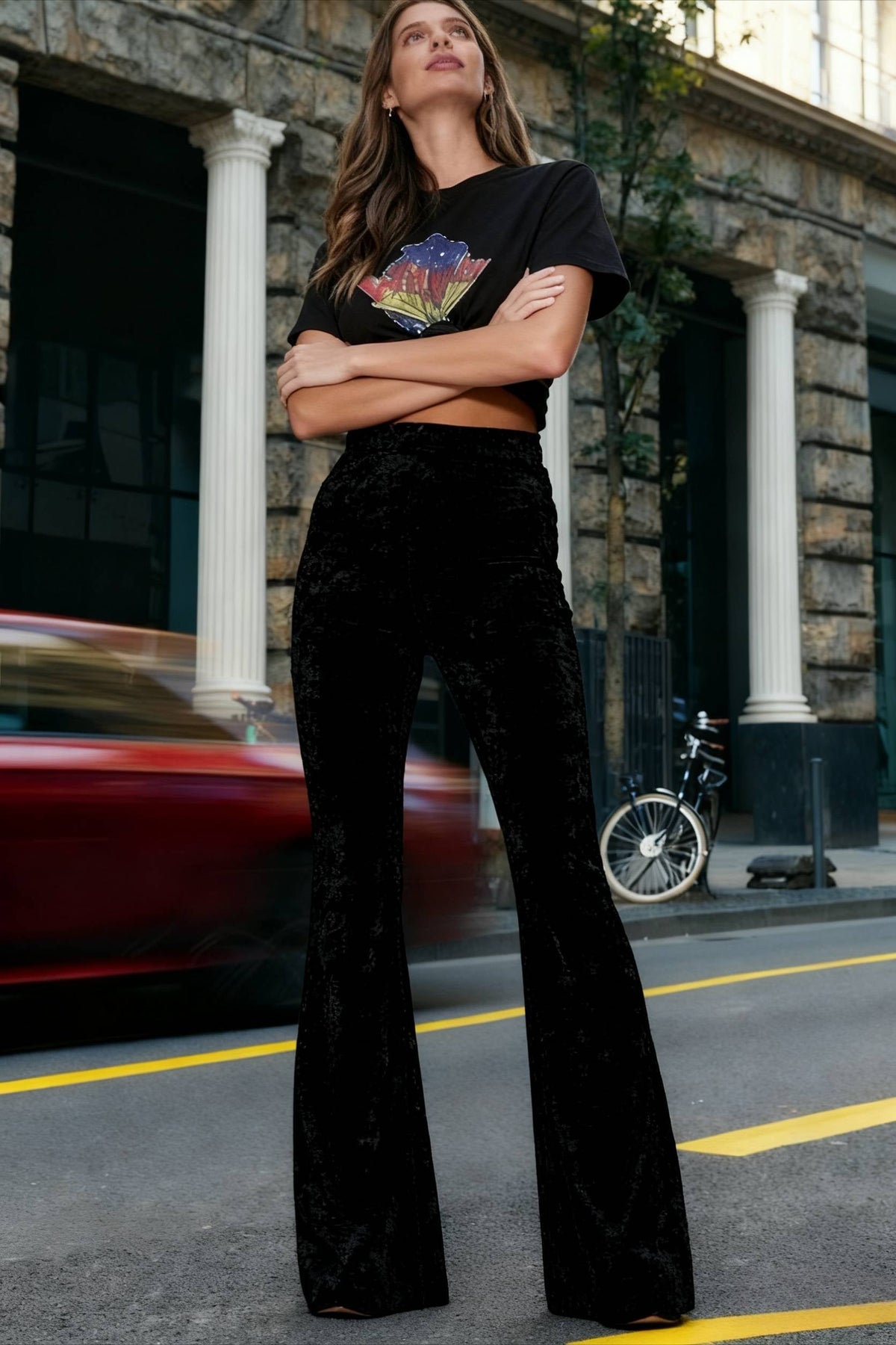 Woman wearing high-waisted wide-leg flared velour trousers