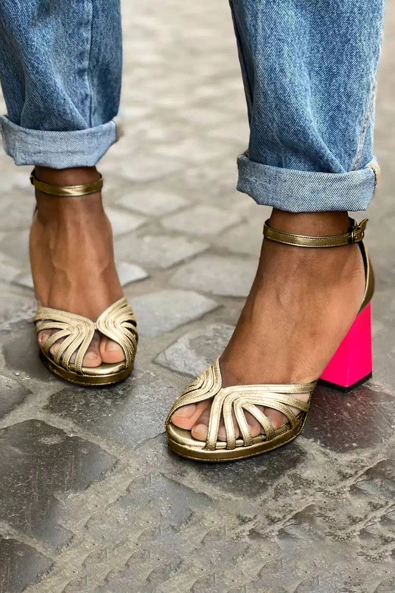 Gold open-toe sandals with ankle strap and bright pink block heel
