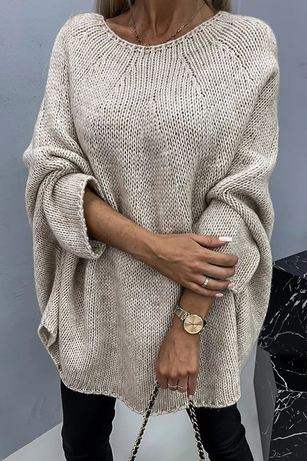 Women's loose knit poncho sweater with crew neckline and wide sleeves