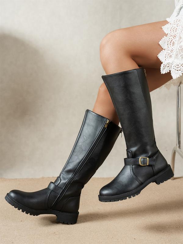 Women's knee-high boots with side zip, buckle strap and lug sole