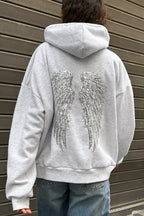 Women's relaxed hooded sweatshirt with sequin wing graphic on the back
