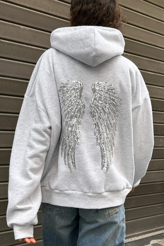 Women's relaxed hooded sweatshirt with sequin wing graphic on the back