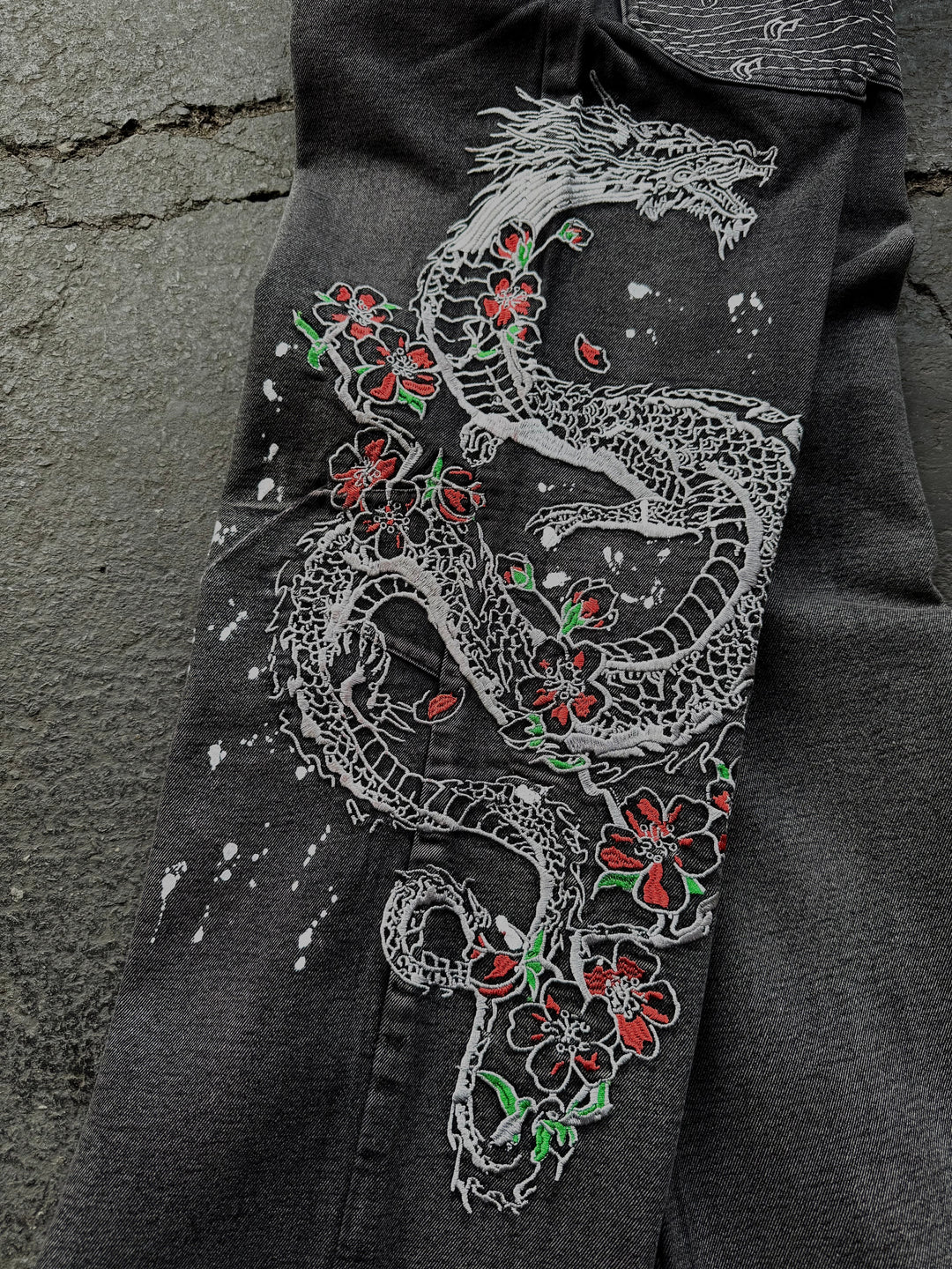 Dark washed wide leg jeans with dragon and floral embroidery