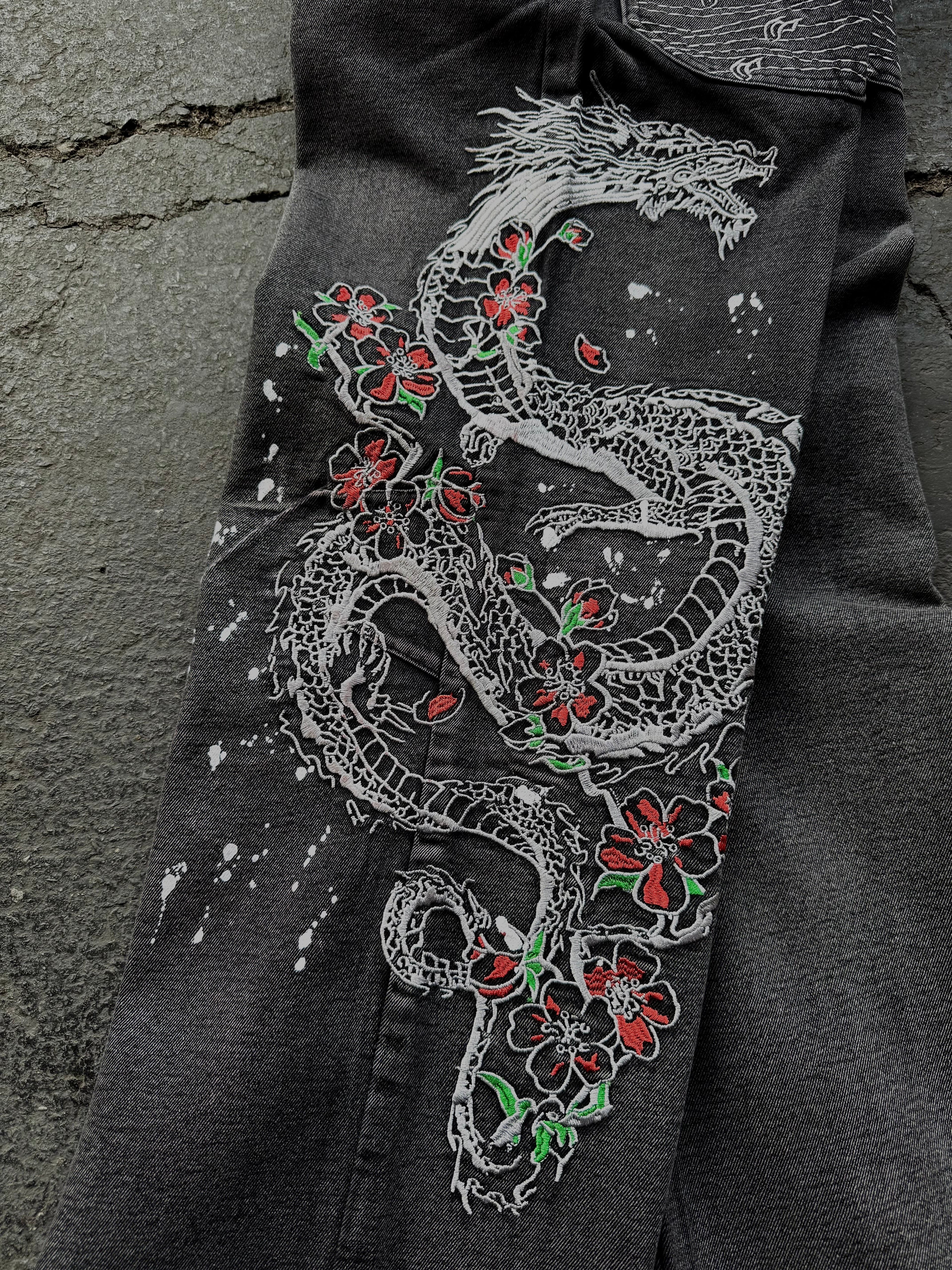 Dark washed wide leg jeans with dragon and floral embroidery