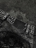 Women's black wide-leg jeans with graphic printed panels and flap pockets