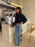Women's light blue wide leg jeans with studded star leg details