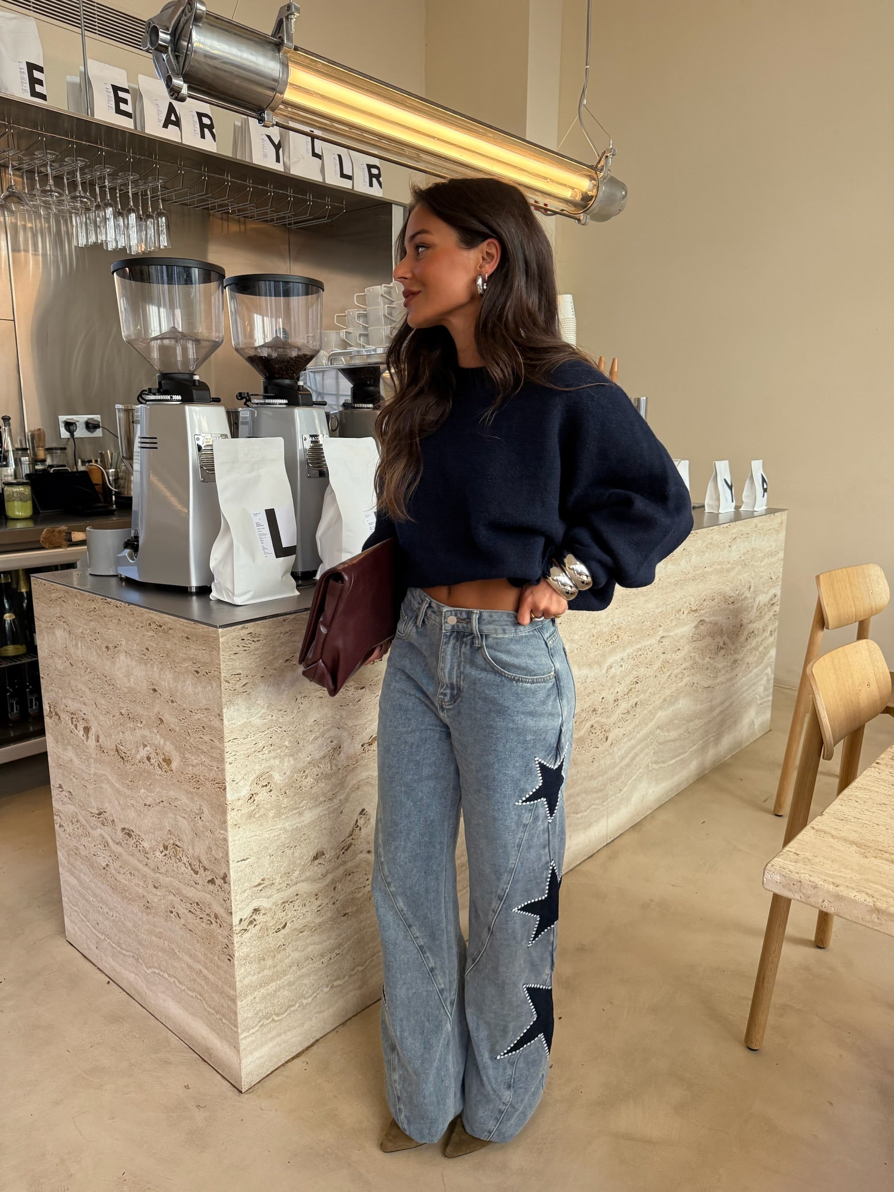 Women's light blue wide leg jeans with studded star leg details