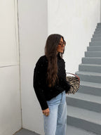 Women's black mock neck sweater with button details