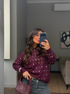 Women's burgundy sweater with scattered silver stud embellishments