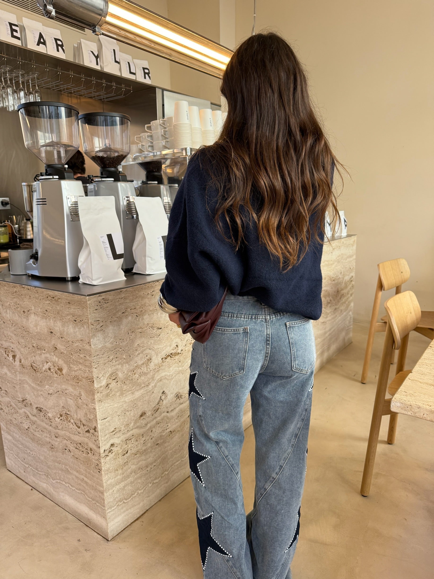 Women's light blue wide leg jeans with studded star leg details