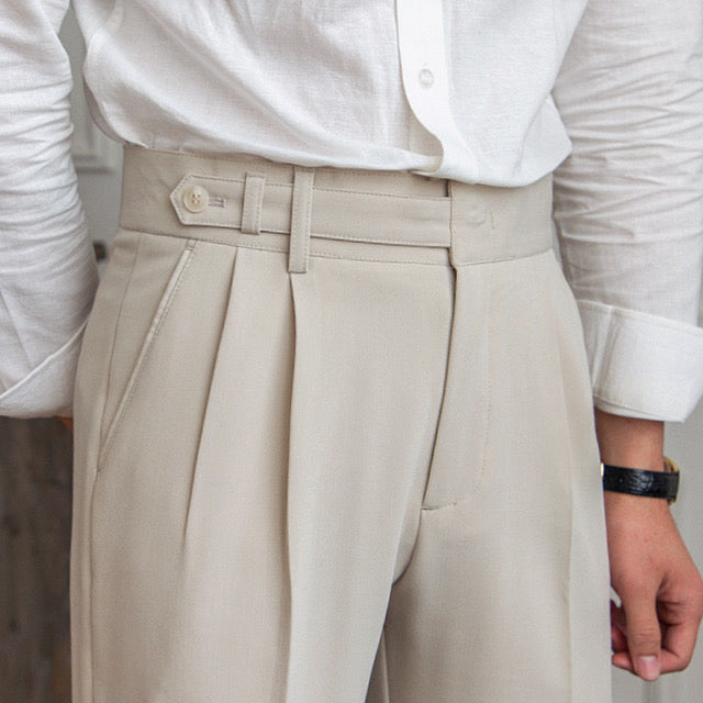 Women's high-waisted pleated straight-leg trousers shown in beige and black
