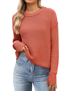 Women's black cropped knit sweater with crew neck and long sleeves