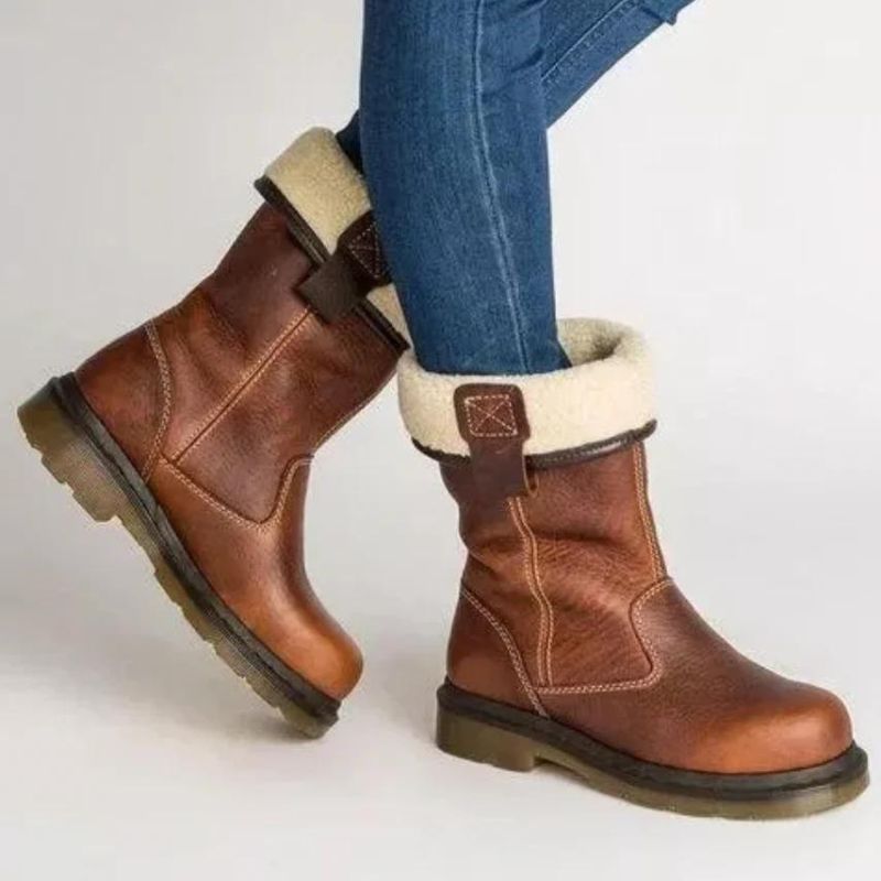 Brown fur-lined ankle boots with cream cuffs and buckle details