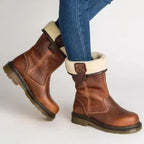 Brown fur-lined ankle boots with cream cuffs and buckle details