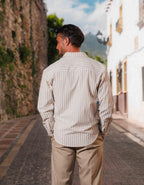 Men's white and taupe striped oversized shirt with open collar and long sleeves