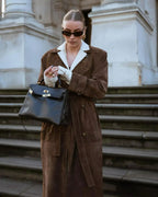 Women's brown long trench coat with contrast lapels and belted waist