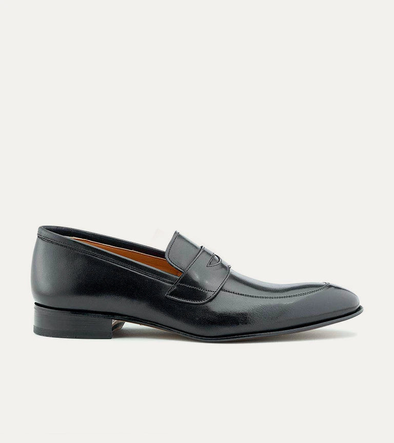 Black men's penny loafer with glossy finish and low heel