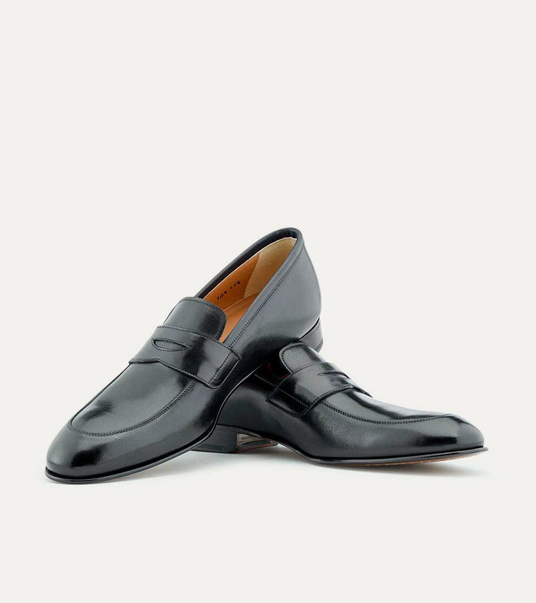 Black men's penny loafer with glossy finish and low heel