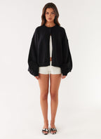 Women's black cardigan with one button and long sleeves
