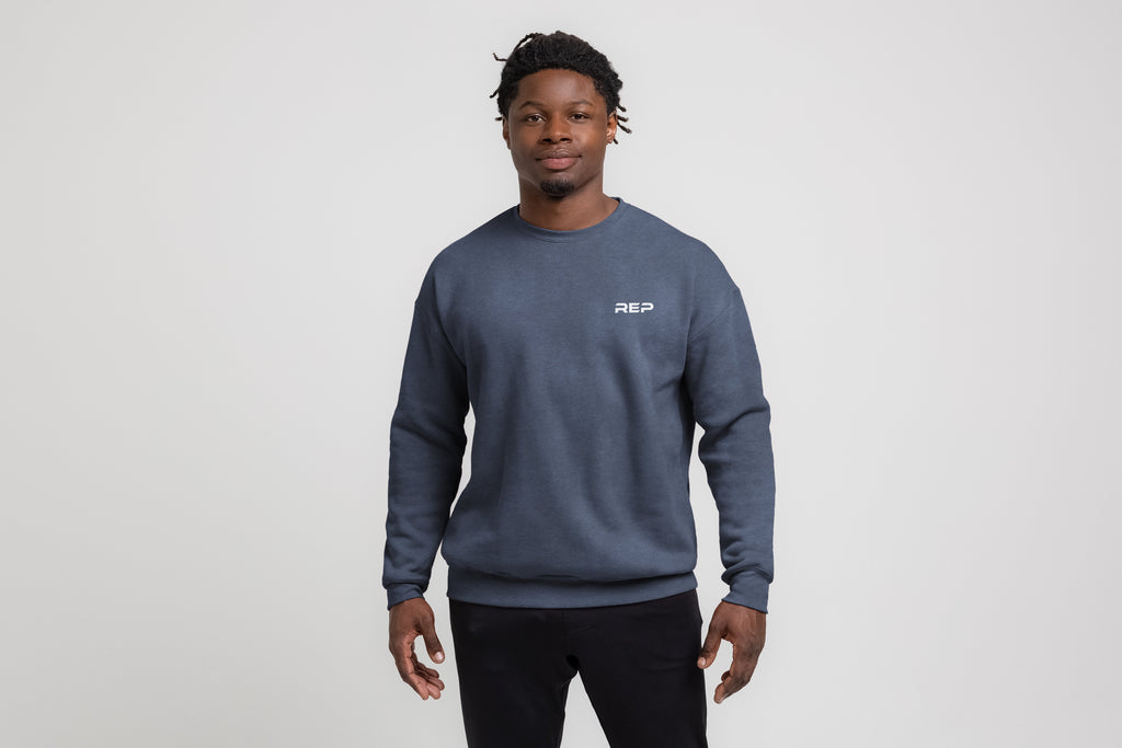 Unisex heather navy crewneck sweatshirt with white chest logo