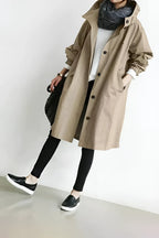 Women's long hooded trench coat with button front and elasticated cuffs
