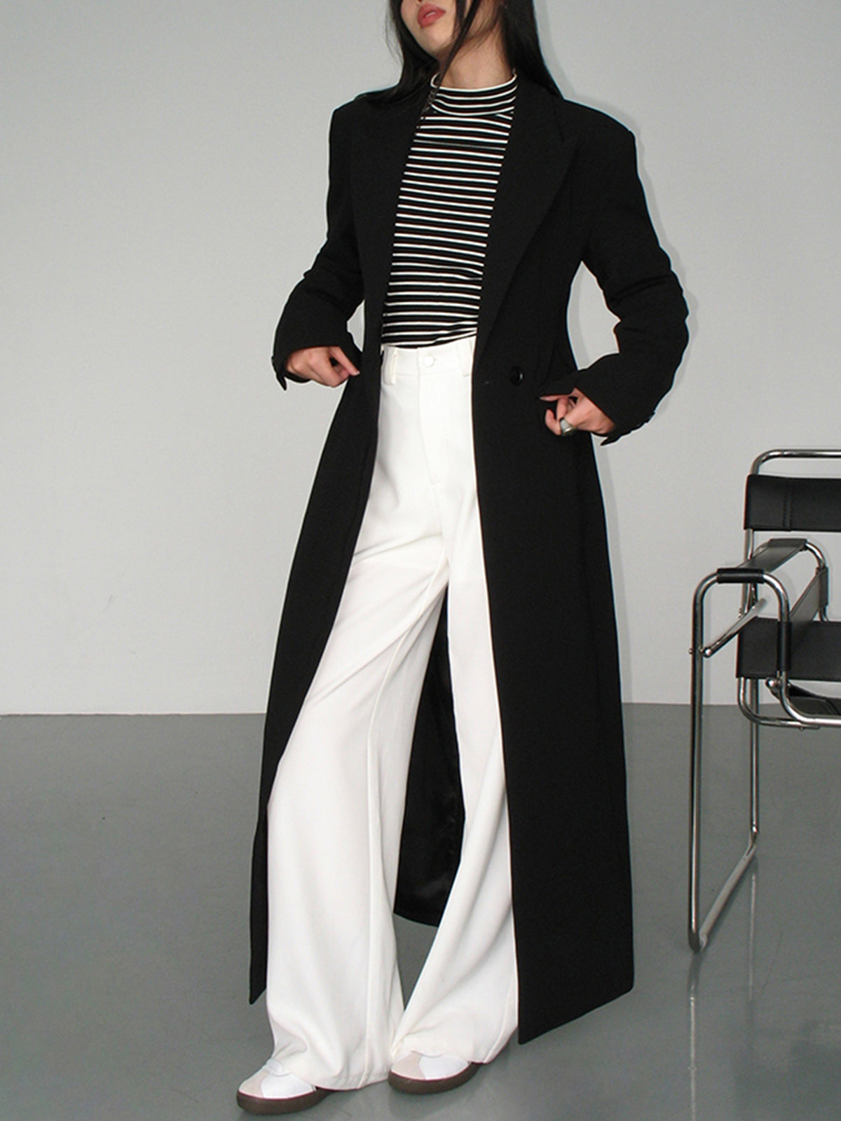 Women's long black tailored coat with lapels and one-button closure