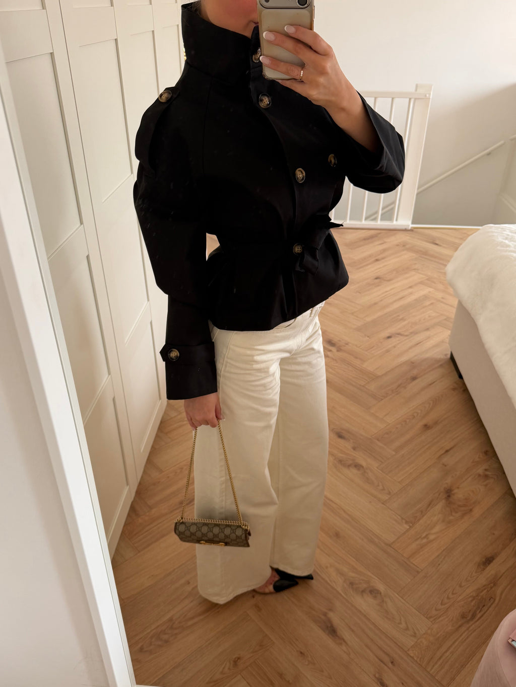Women's black short trench coat with high collar, button front and tie belt