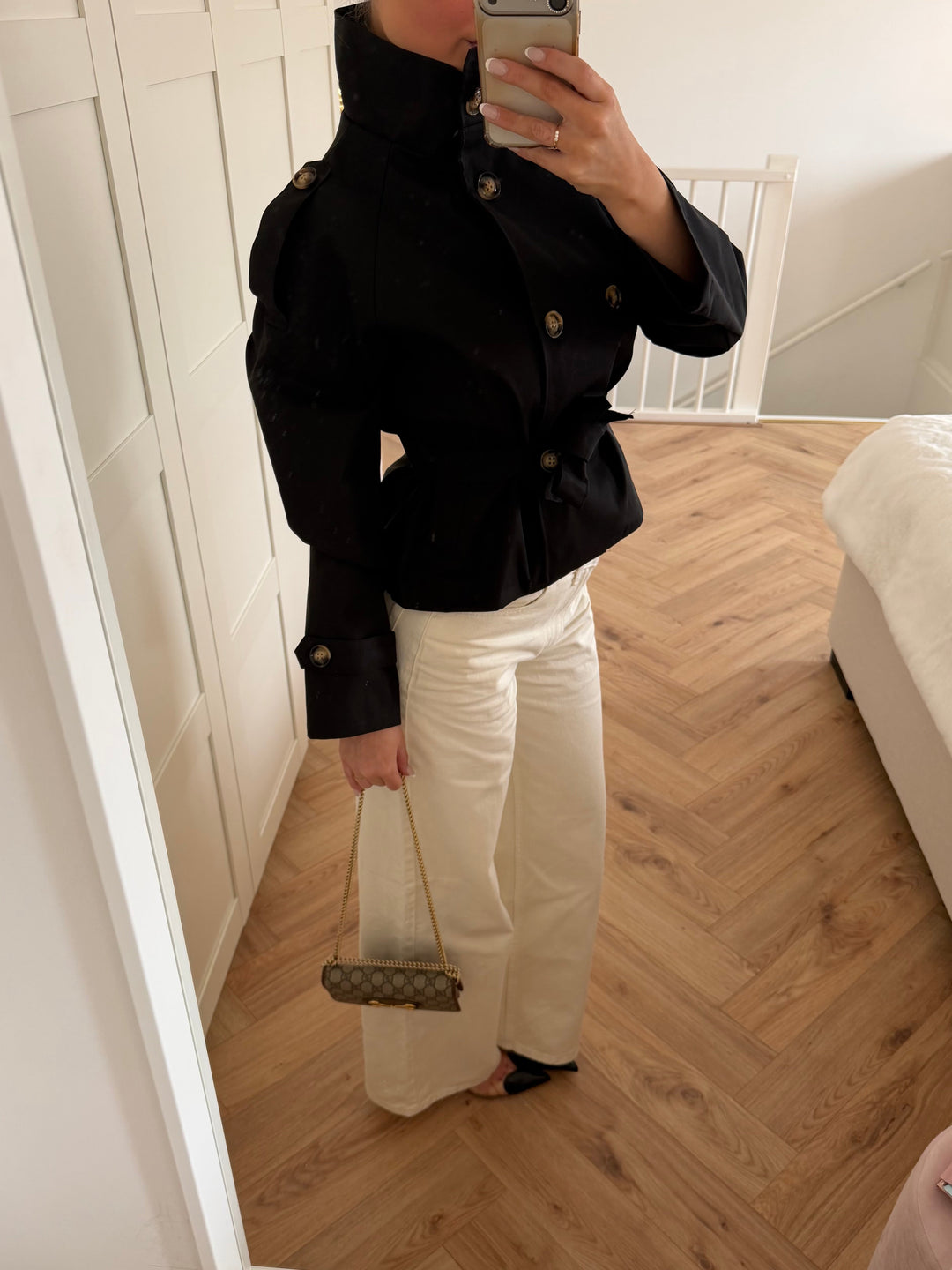 Women's black short trench coat with high collar, button front and tie belt