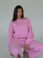 Women's pink cropped crewneck sweatshirt with long sleeves and ribbed trims