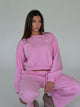 Women's pink cropped crewneck sweatshirt with long sleeves and ribbed trims