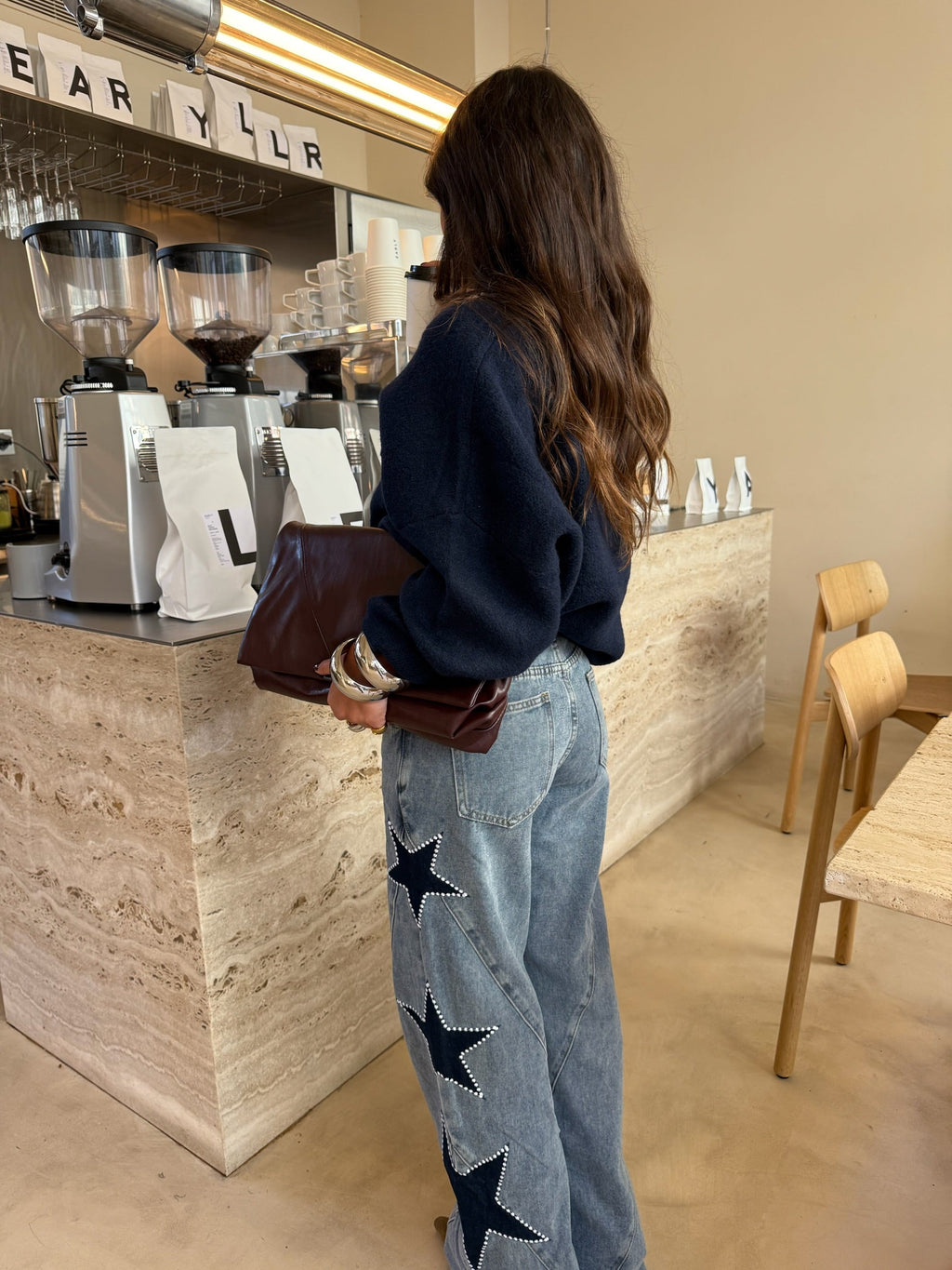 Women's light blue wide leg jeans with studded star leg details