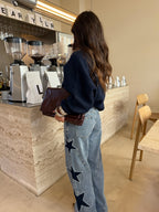 Women's light blue wide leg jeans with studded star leg details